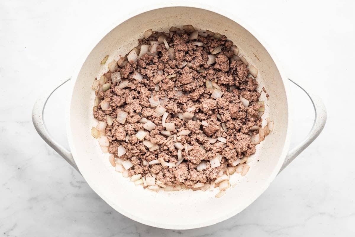 Gesunde 30-Minuten-Hamburger-Suppe 3 Nahaufnahme der Zutaten für die Hackfleischsuppe: Hackfleisch, gewürfelte Kartoffeln, Karotten, grüne Bohnen, Tomaten und Zwiebeln.