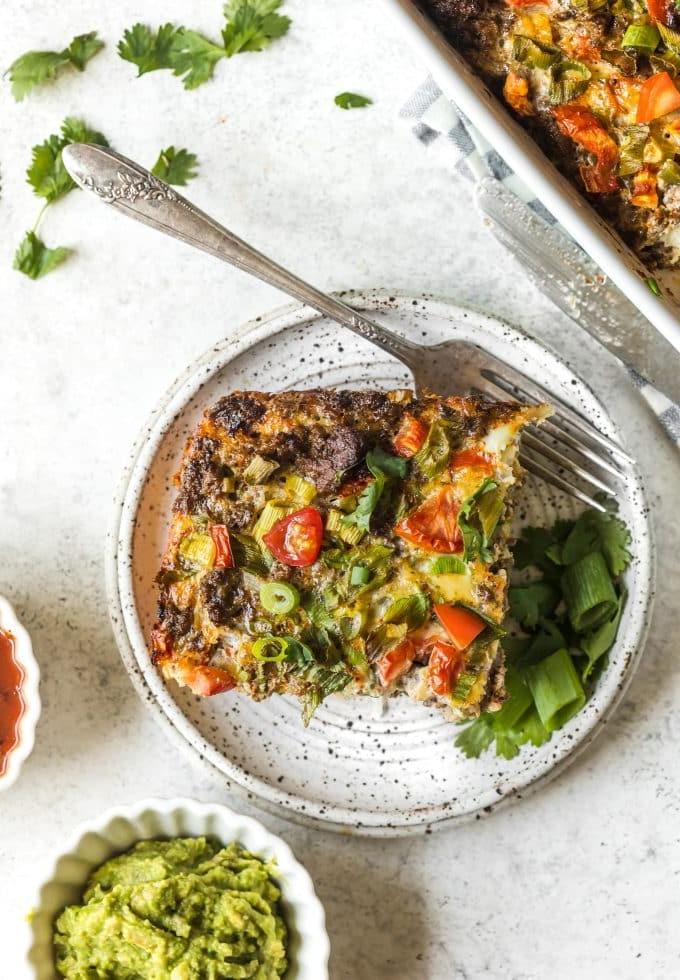 Nahaufnahme des herzhaften mexikanischen Frühstücksauflaufs, der die Zutaten wie Hackfleisch, Paprika und Kartoffeln zeigt.