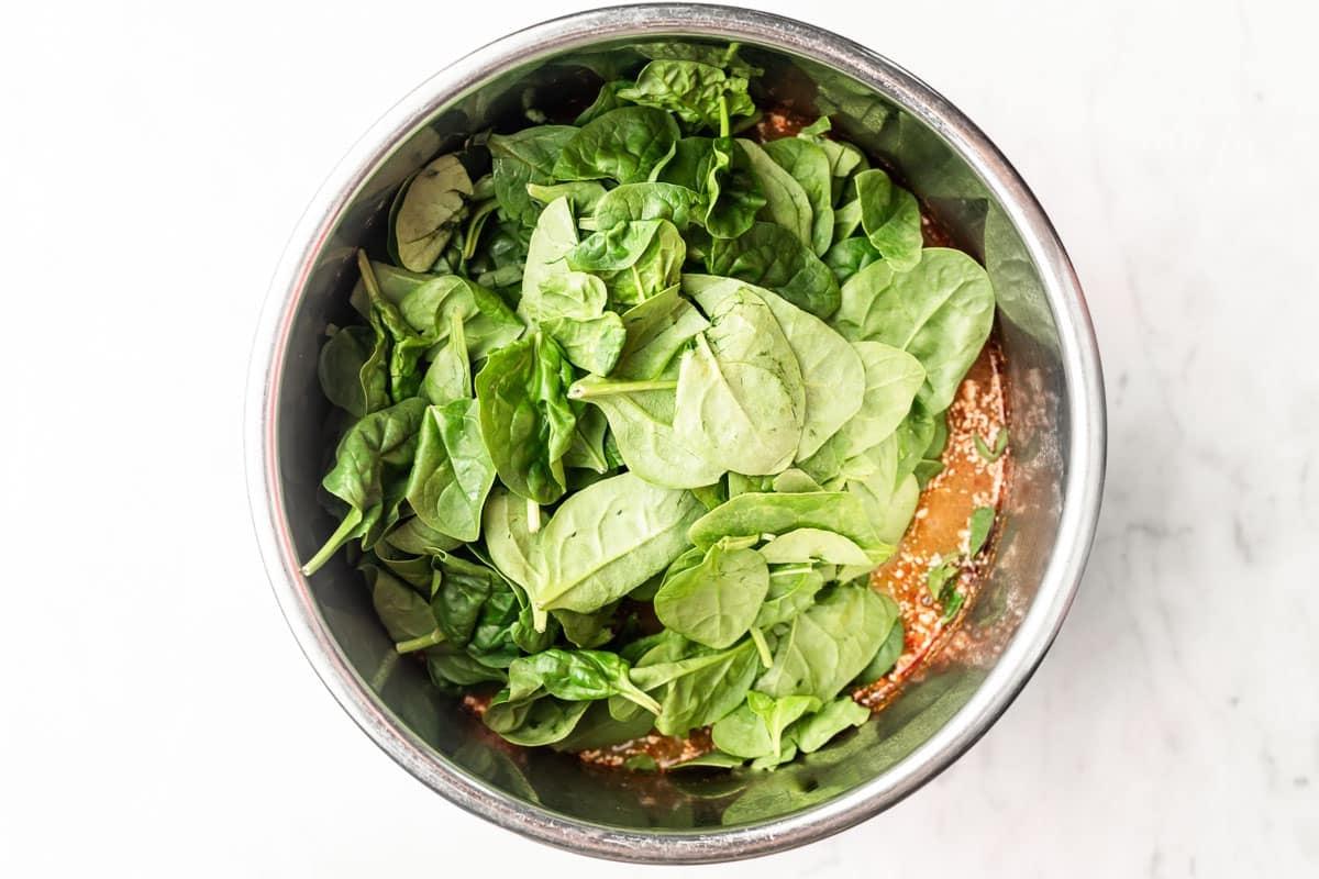 Eine Nahaufnahme der fertigen Instant Pot Buffalo Hähnchen Süßkartoffel Suppe mit frischen Kräutern garniert.