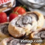 Εύκολα Στριφογυρίσματα Νουτέλας 6 Στρογγυλάκια Nutella με σφολιάτα σε πιάτο.