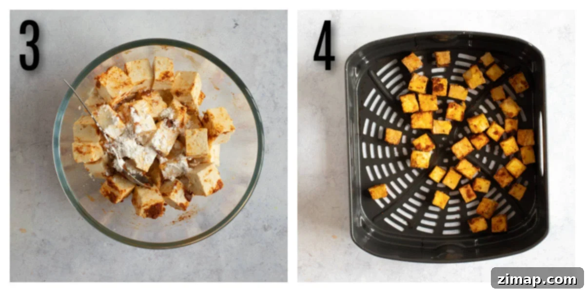 Τραγανό Τόφου Αέρος 7 Tofu cubes in an air fryer basket.