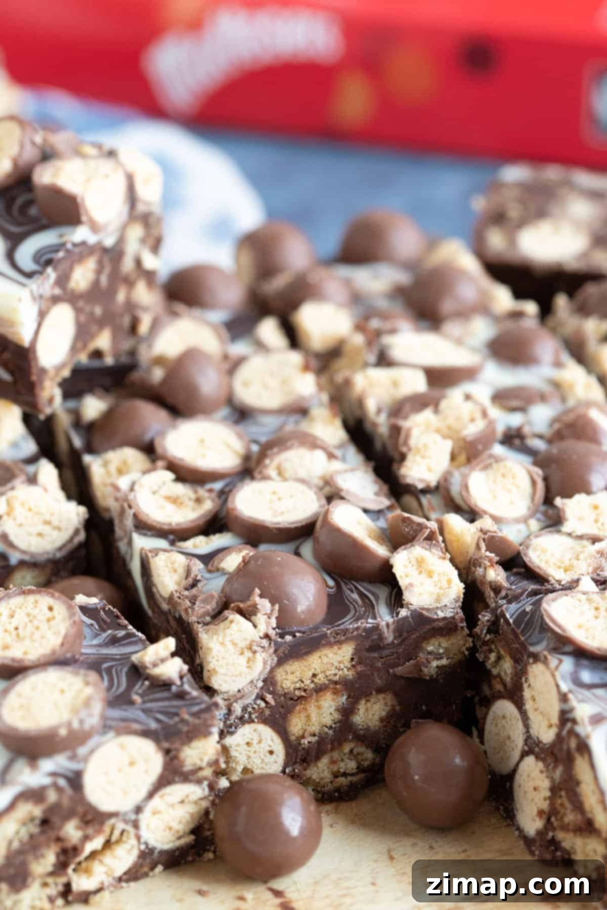 Το Αξεπέραστο Μπισκοτογλυκό Μαλτέζερ 7 Malteser tiffin on a wooden board.