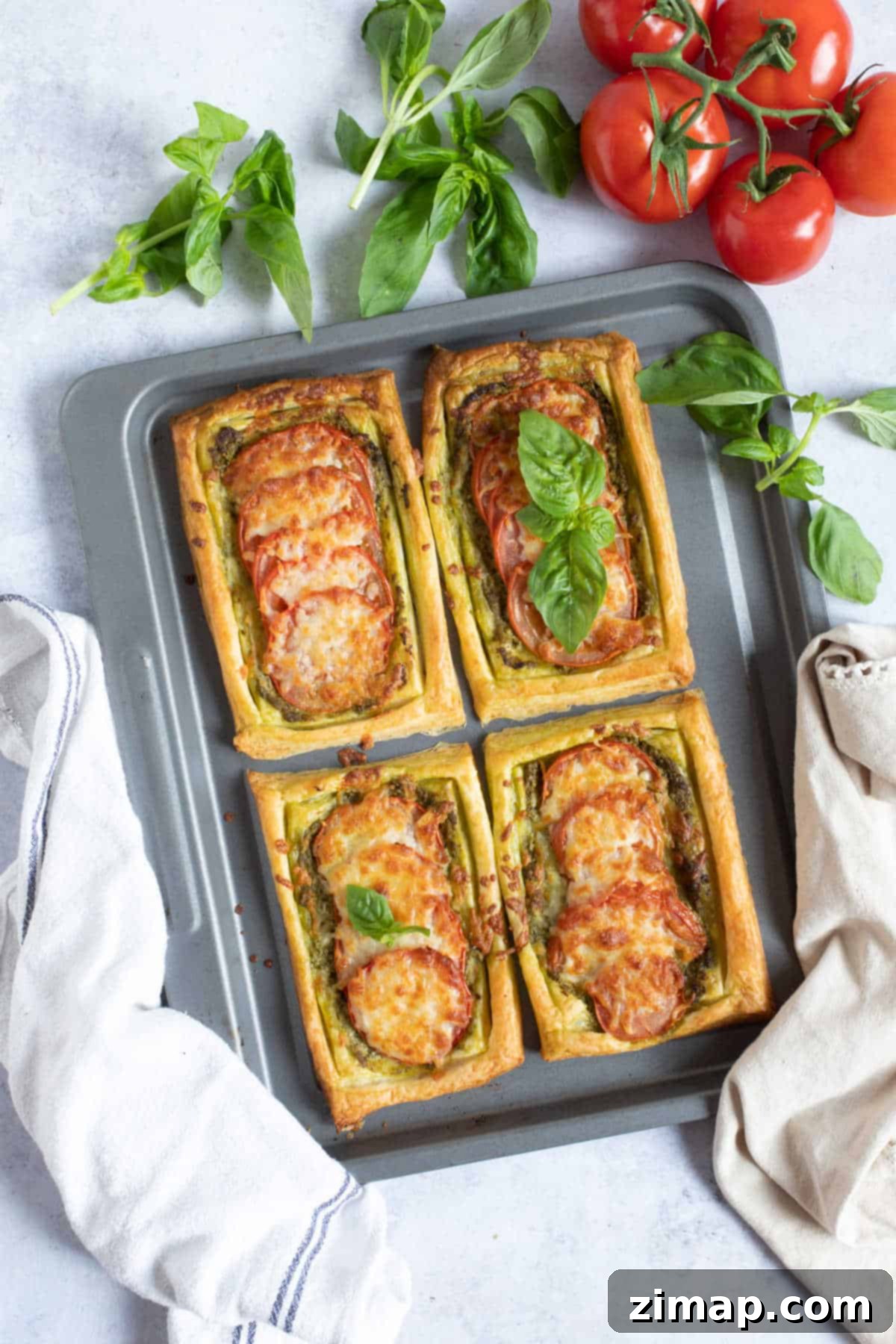 Σφολιατοταρτάκια πανεύκολα 7 Easy puff pastry tarts on a baking sheet.