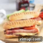 Εύκολο Πανίνι στη Φριτέζα Αέρος με Ζαμπόν και Μπρι 10 Gourmet air fryer panini on a wooden board.