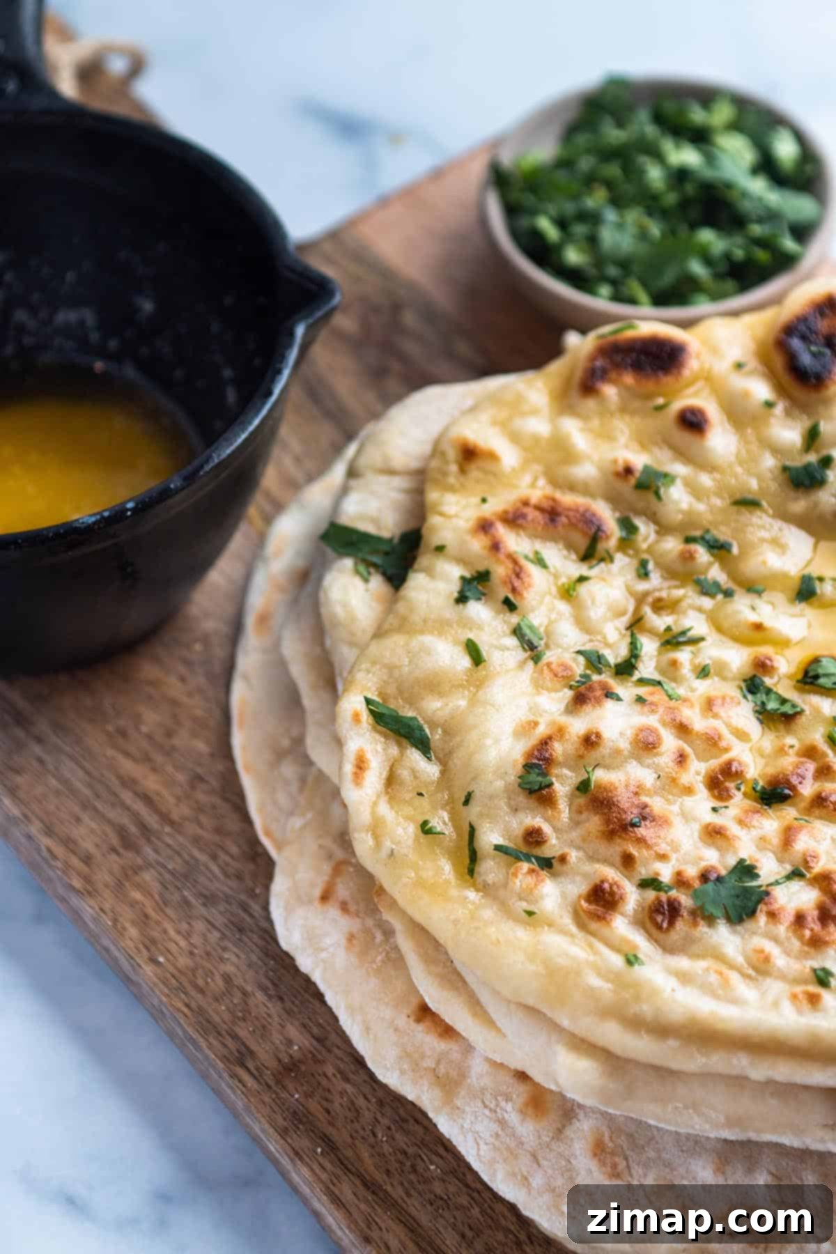 Προζυμένιο Νάαν με περίσσευμα 10 Στοίβα από naan με προζύμι με λιωμένο βούτυρο και φρέσκο κόλιανδρο.