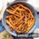 Εύκολες Τηγανητές Γλυκοπατάτες Αέρος 7 Ένα μπολ με καρυκευμένες γλυκοπατάτες air fryer.